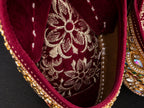 Burgundy and gold embellished Punjabi juttis - styled view